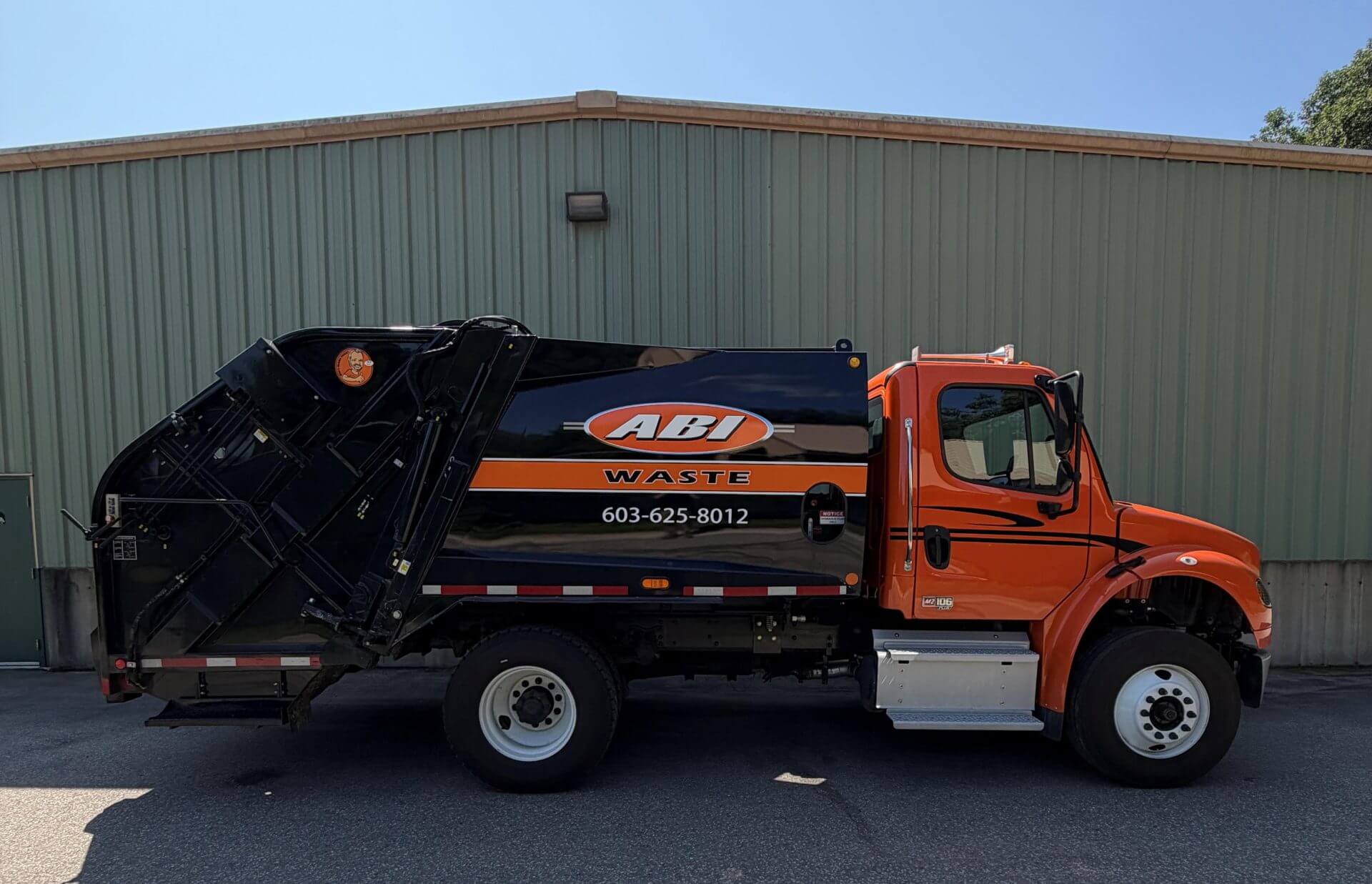 Orange and black trash truck